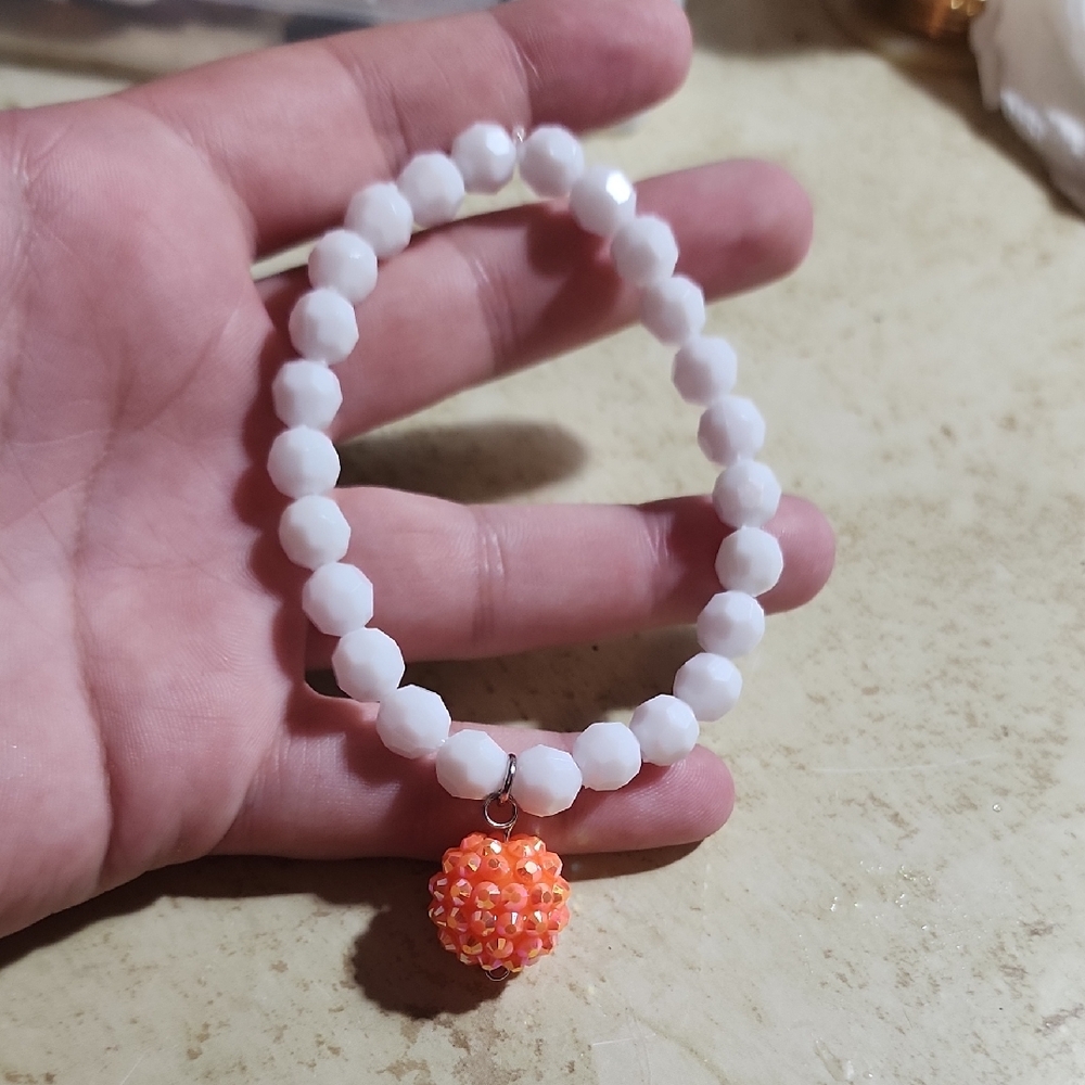 White Beaded Bracelet with Orange Charm